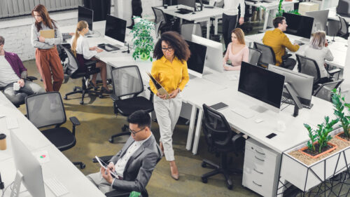 high angle view of professional young business people working with computers and papers in office